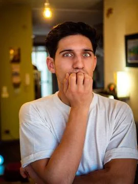 Nervous guy looking away alone at home Stock Photos