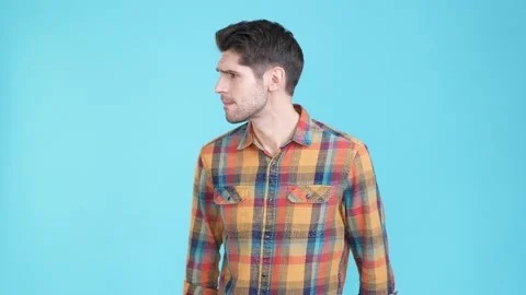 Nervous guy wave hand no one see look isolated blue color background Stock Footage 170065432