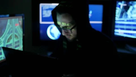 Nervous hacker working on computer, Criminal hacker cracking system, while green Stock Footage 76013026