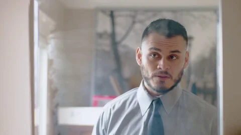 Nervous hispanic man practicing introduction in front of mirror Stock Footage 84487123