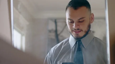 Nervous hispanic man practicing sales pitch in mirror as he gets ready Stock Footage 84483898