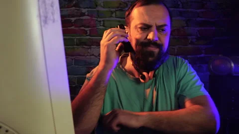 Nervous IT Technician Software Developer Answering Call on Flip Mobile Phone in Stock Footage 301505435