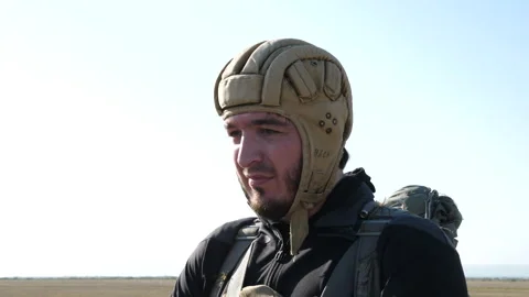 Nervous man with black beard prepares for parachute jump Stock Footage 144343683