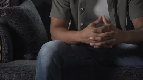 Nervous man clasping hands on sofa Stock Footage 317056110