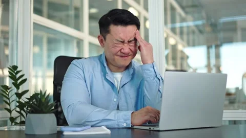 Nervous man closing eyes while struggling with hurting head in corporate office 스톡 동영상 276423445