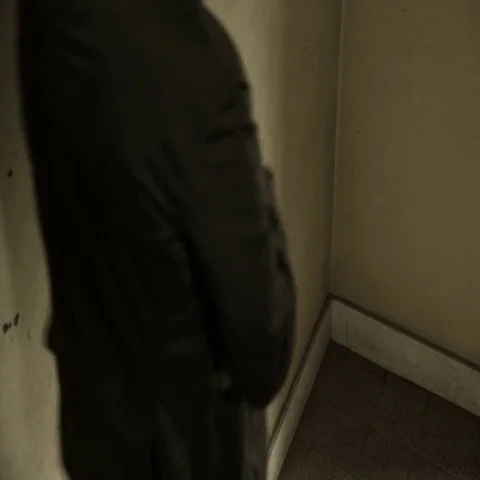  nervous man comes down the stairs at home talking nervously on the phone Stock Footage 69513645