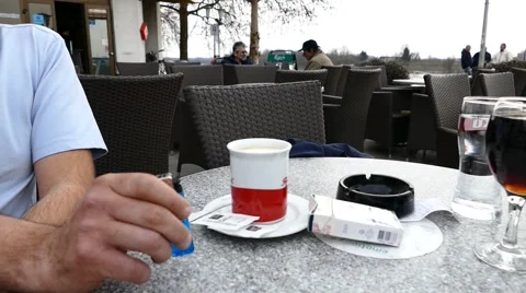 Nervous Man Drinking Coffee And Playing With A Lighter Stock Footage 47339707