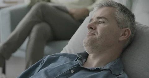 Nervous man lying on the therapist couch Stock Footage 162354322