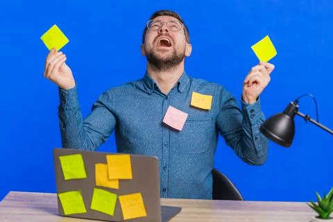 Nervous man with pasted sticker notes use laptop having concentration problem Stock Photos