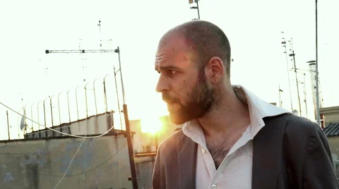 Nervous man smokes a cigarette while waiting anxiously for someone Stock-Footage 69015758