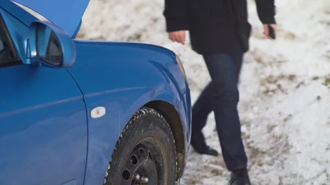 Nervous man touching dent from damage on car body Stock Footage