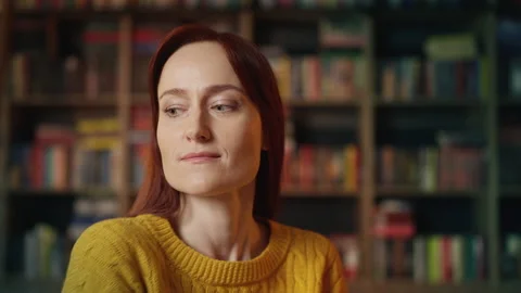 Nervous red-haired woman waiting for date who stood her up in urban library Stock Footage 340267220