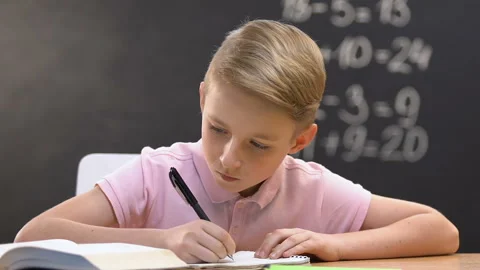 Nervous schoolboy doing home task, throwing copy book pages, wrong solution Stock Footage 110659017