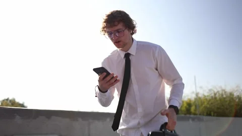 Nervous student walking to an important university exam while checking phone Stock Footage 346363014
