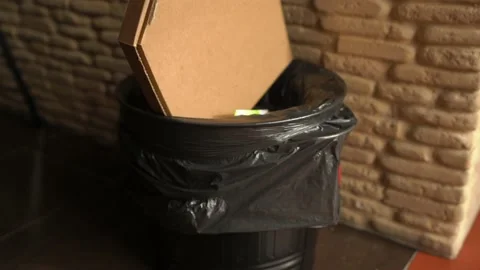 Nervous stuffing a Pizza Box in the Trash Can Stock Footage 148126672