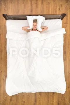 The nervous woman lay on the bed. View from above Stock Photos