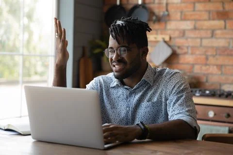 Nervous young black male angry with spam on laptop screen Stock Photos
