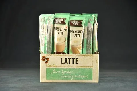 NESCAFE LATTE opened box with coffee sachets on a dark background Stock Photos