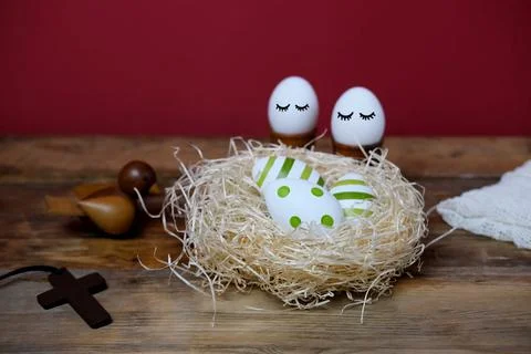 Nest with colored easter egg with painted pattern, christian cross, religion  Stock Photos