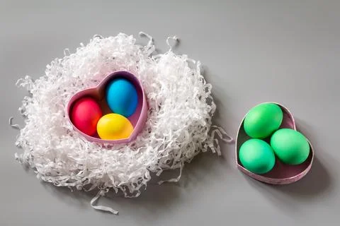 Nest with colored Easter eggs and gift box. Stock Photos