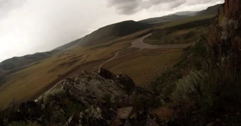 Nest with eaglets on a rock and mountain river valley under cloudy sky 動画素材 57401119