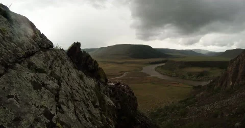Nest with eaglets on a rock and mountain river valley under cloudy sky 動画素材 57401136