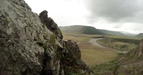Nest with eaglets on a rock and mountain river valley under cloudy sky 動画素材 57401183