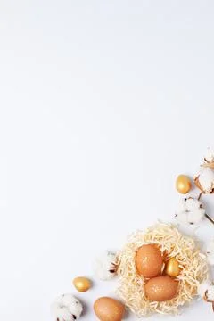 Nest with easter eggs with flowers on white background. Flat lay, copy space Stock Photos