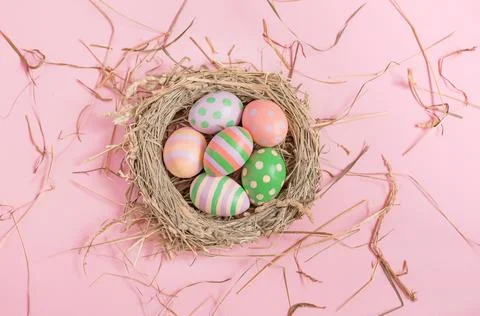 Nest with Easter eggs on a pink background Stock Photos