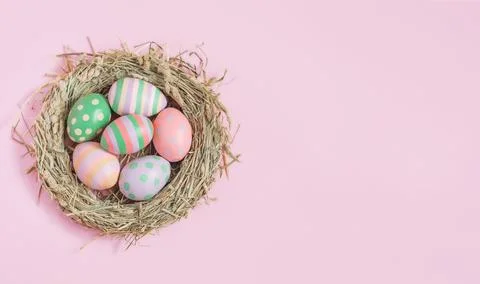 Nest with Easter eggs on pink background, Easter, holiday, postcard Stock Photos