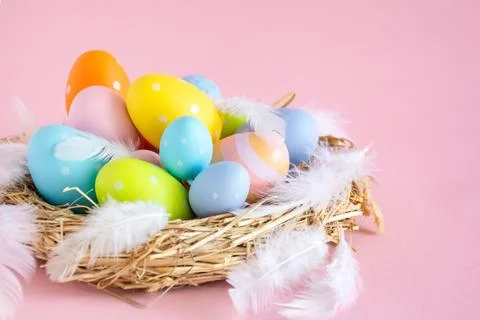 Nest with Easter eggs on a pink background with a copy space Stock Photos