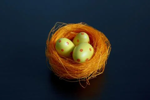 Nest with Easter eggs in specks. Stock Photos