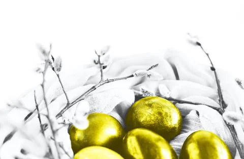 Nest of fabric with Easter eggs decorated with pussy willow in trendy yellow and Stock Photos