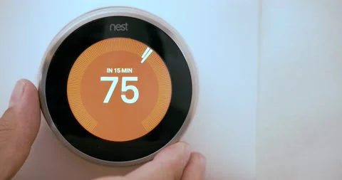 Nest Learning Smart Thermostat.  An electronic, programmable self-learning Wi-Fi Video stock 163682918