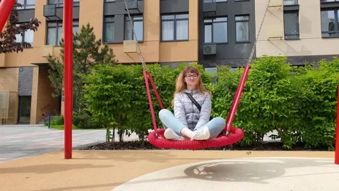 Nest Swing. Bottom view on young woman swinging on Nest Swing. Red Nest Swing 動画素材 131436685