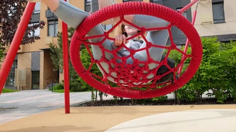 Nest Swing. Bottom view on young woman is swinging on a swing. Red Nest Swing 動画素材 132893111