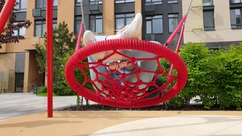 Nest Swing. Bottom view on young woman is swinging on a swing. Red Nest Swing 스톡 동영상 134171137