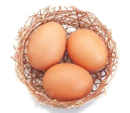 Nest of twigs and a group of Easter eggs. On a white background. Stock Photos