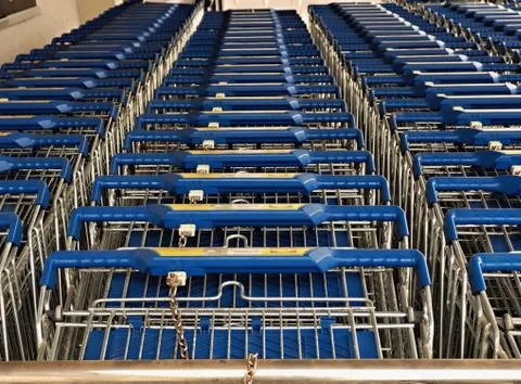 Nested shopping cart of a discounter, three rows next to each other Stock Photos