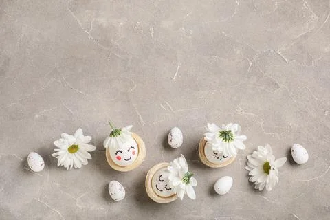 Nests of creative Easter eggs with flowers on grunge grey background Stock Photos