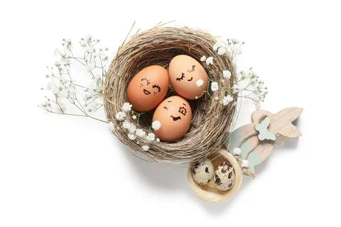Nests with creative Easter eggs, flowers and wooden rabbit isolated on white  Stock Photos