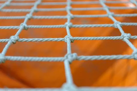 A net of thin ropes on the playground, close-up. Stock Photos