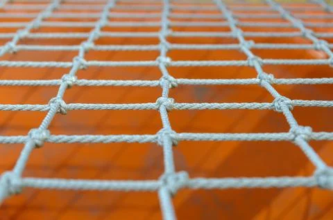 A net of thin ropes on the playground, close-up. Stock Photos