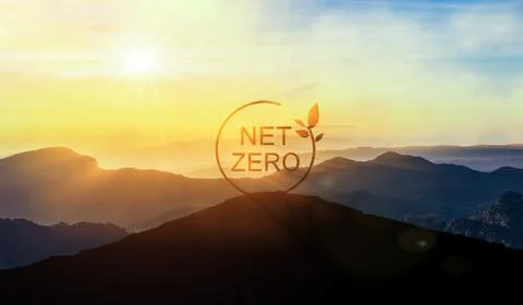 Net Zero sign on top of mountain at sunset, surrounded by eco-friendly natu.. Stock Photos