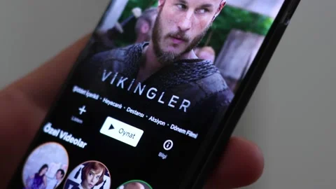 Netflix app. Man using Netflix application on mobil phone. Stock Footage 144769053