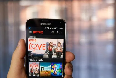 Netflix application on cell phone. Stock Photos