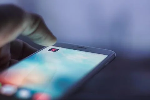 Netflix button on smartphone Stock Photos