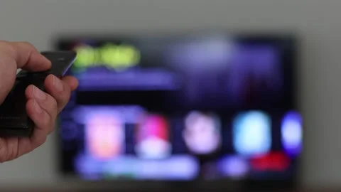 Netflix on Smart TV screen browsing trough movies to watch with remote control Stock Footage 144779648