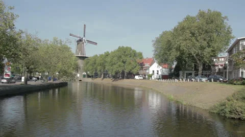 Netherlands canal with tall windmill Stock Footage 24830176