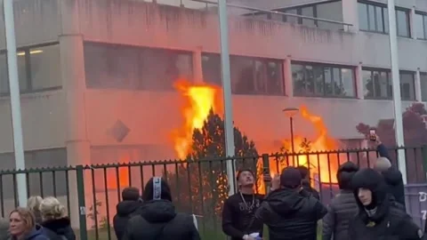 Netherlands: Fire Erupts Outside Asylum Shelter During Violent Protest In... Stock Footage 334819434